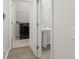 A peek into the utility room featuring a pedestal sink, ceramic tile floors and a doorway to the laundry area at 341 Witch Hazel St, Summerville, SC 29486