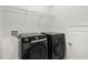 Laundry room featuring a modern, front load washer and dryer, with wire shelving for storage at 341 Witch Hazel St, Summerville, SC 29486