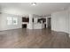 Open-concept living room showcasing wood floors and easy access to kitchen with dark wood cabinets at 341 Witch Hazel St, Summerville, SC 29486