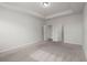 Bright main bedroom featuring tray ceiling, neutral carpet, and two doors at 341 Witch Hazel St, Summerville, SC 29486