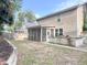 Backyard featuring a screened porch and stone outdoor kitchen, perfect for entertaining and enjoying the outdoors at 3632 Locklear Ln, Mount Pleasant, SC 29466