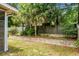 Fenced backyard with mature trees, palms, brick landscaping and grassy areas at 3632 Locklear Ln, Mount Pleasant, SC 29466