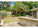Enjoy a private backyard with a built-in outdoor kitchen and stone retaining wall landscaping at 3632 Locklear Ln, Mount Pleasant, SC 29466
