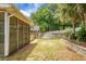 Backyard with screen enclosure, outdoor kitchen area, mature trees and perimeter privacy fence at 3632 Locklear Ln, Mount Pleasant, SC 29466