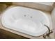 This is a soaking tub with jets surrounded by beige tile and a shiny faucet at 3632 Locklear Ln, Mount Pleasant, SC 29466