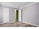 The bedroom showcases hardwood floors, two white doors, and light grey walls for a minimalist aesthetic at 3632 Locklear Ln, Mount Pleasant, SC 29466