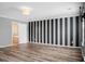 Bedroom features an accent wall, hardwood floors and an open bathroom at 3632 Locklear Ln, Mount Pleasant, SC 29466