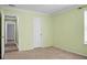 View of a bedroom shows carpeted floors and a door leading to another room with wood flooring at 3632 Locklear Ln, Mount Pleasant, SC 29466