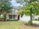 Charming home with a lush green lawn, mature trees, and an attached two-car garage at 3632 Locklear Ln, Mount Pleasant, SC 29466