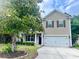 Charming two-story home features a well-manicured lawn, attached garage, and neutral siding at 3632 Locklear Ln, Mount Pleasant, SC 29466