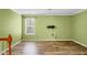 Living room with hardwood flooring, a window, light green paint and neutral trim at 3632 Locklear Ln, Mount Pleasant, SC 29466