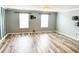 Bright living room featuring modern laminate floors and natural light from two windows at 3632 Locklear Ln, Mount Pleasant, SC 29466
