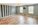 Spacious living room with striped accent wall and laminate floors at 3632 Locklear Ln, Mount Pleasant, SC 29466