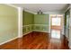 Spacious living room featuring elegant crown molding, wainscoting, and gleaming hardwood floors at 3632 Locklear Ln, Mount Pleasant, SC 29466