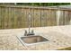 Outdoor sink with granite countertops and a chrome faucet, set against a wooden fence at 3632 Locklear Ln, Mount Pleasant, SC 29466