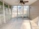Enclosed screen porch with ceiling fan and neutral tile floor; ideal for outdoor relaxation and entertaining at 3632 Locklear Ln, Mount Pleasant, SC 29466