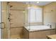 Shower and bathtub featuring designer tile, glass surround, and rainfall shower head at 3632 Locklear Ln, Mount Pleasant, SC 29466