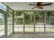 Bright sunroom with tiled floors, ceiling fan and views to the backyard through screened windows at 3632 Locklear Ln, Mount Pleasant, SC 29466