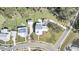 Aerial view of a white two-story home with metal roof, lush landscaping, mature trees, and a green lawn at 3864 Summerton St, Mount Pleasant, SC 29466