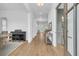 Bright hallway featuring hardwood floors, piano, console table, and doorway to custom cabinetry at 3864 Summerton St, Mount Pleasant, SC 29466