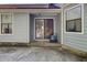 View of the back patio area with sliding glass door entrance and blue vinyl siding at 406 Carolina Cir, Ladson, SC 29456