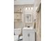 A clean bathroom featuring a vanity with a mirror, toilet, linen cabinet, and towel rack at 406 Carolina Cir, Ladson, SC 29456