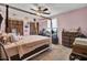 A cozy bedroom featuring a canopy bed with fan, vintage dresser, and wood-paneled closet doors at 406 Carolina Cir, Ladson, SC 29456