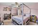 A decorated bedroom with a canopy bed frame, fan, and personal items throughout at 406 Carolina Cir, Ladson, SC 29456