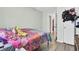 Bright bedroom boasts wood floors and colorful bedding, offering a cozy atmosphere at 406 Carolina Cir, Ladson, SC 29456