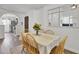 Cozy dining room with hardwood floors, a stylish table arrangement, and an open layout connected to the kitchen at 406 Carolina Cir, Ladson, SC 29456