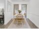 Bright dining area with hardwood floors, a modern table setting, and natural light, perfect for Gathering meals at 406 Carolina Cir, Ladson, SC 29456