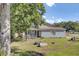 Charming home with blue siding, a cozy front porch, a fire pit, and a tree at 406 Carolina Cir, Ladson, SC 29456