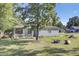 Quaint home featuring blue siding, a cozy front porch, and a fire pit, perfect for outdoor gatherings at 406 Carolina Cir, Ladson, SC 29456