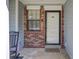 Welcoming front entrance featuring brick accents and a 'HOME' doormat, creating an inviting curb appeal at 406 Carolina Cir, Ladson, SC 29456