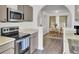 Kitchen with stainless steel appliances and dining area with table set for a cozy meal at 406 Carolina Cir, Ladson, SC 29456