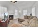 Bright living room with hardwood floors, a cozy fireplace, and a comfortable sectional sofa, ideal for relaxation at 406 Carolina Cir, Ladson, SC 29456