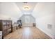 An attic area is set up as an office with a window, desk, and wood flooring at 413 Eagleview Dr, Moncks Corner, SC 29461