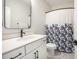 Clean bathroom with a single vanity, toilet, and a shower/tub with a blue-and-white patterned curtain at 413 Eagleview Dr, Moncks Corner, SC 29461