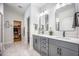 This bathroom features a double vanity with gray cabinets, black hardware, and marble floors at 413 Eagleview Dr, Moncks Corner, SC 29461
