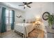 A light-filled bedroom offers wood floors, shutters, and a decorative round mirror at 413 Eagleview Dr, Moncks Corner, SC 29461
