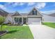 Charming home with a manicured lawn, covered porch, and a two-car garage at 413 Eagleview Dr, Moncks Corner, SC 29461