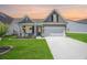 Charming home with a manicured lawn, covered porch, and a two-car garage at 413 Eagleview Dr, Moncks Corner, SC 29461