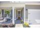Welcoming front porch with seating, hanging plants, and a glass-paneled front door at 413 Eagleview Dr, Moncks Corner, SC 29461