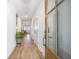Bright hallway featuring wood floors, white walls, and a view into the living spaces at 413 Eagleview Dr, Moncks Corner, SC 29461