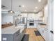 Spacious kitchen features white cabinets, stainless appliances, and a large central island with barstool seating at 413 Eagleview Dr, Moncks Corner, SC 29461