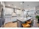 Modern kitchen boasts white cabinets, stainless steel appliances, a large island, and pendant lighting at 413 Eagleview Dr, Moncks Corner, SC 29461