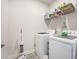 A functional laundry room features a washer, dryer, and shelving for storage and organization at 413 Eagleview Dr, Moncks Corner, SC 29461