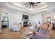 Bright living room with a fireplace, tray ceiling, and comfortable seating arrangement at 413 Eagleview Dr, Moncks Corner, SC 29461