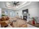 Inviting living room features a fireplace, plush seating, decorative rug, and tray ceiling with ceiling fan at 413 Eagleview Dr, Moncks Corner, SC 29461