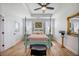 A bright main bedroom features a four-poster bed, wood floors, and decorative mirror at 413 Eagleview Dr, Moncks Corner, SC 29461